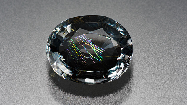 Gray musgravite displaying iridescence.