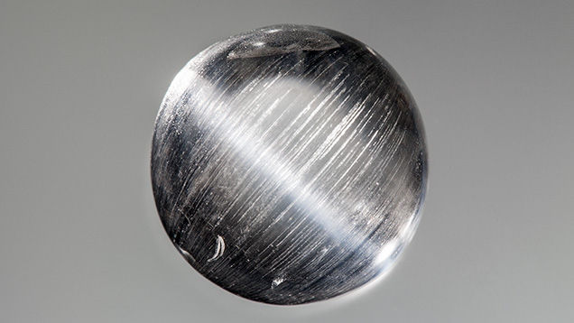 Phenakite with cat’s eye viewed with point-source illumination. Phenakite with cat’s eye viewed with point-source illumination.