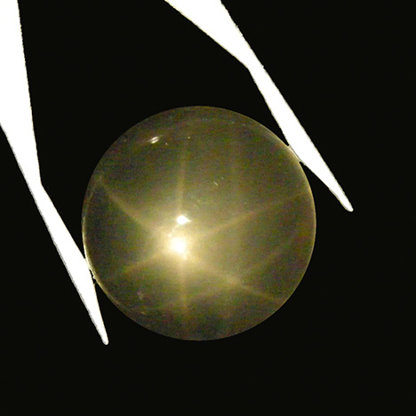 Very light rose quartz cabochon from Brazil showing double stars in reflected light Very light rose quartz cabochon from Brazil showing double stars in reflected light