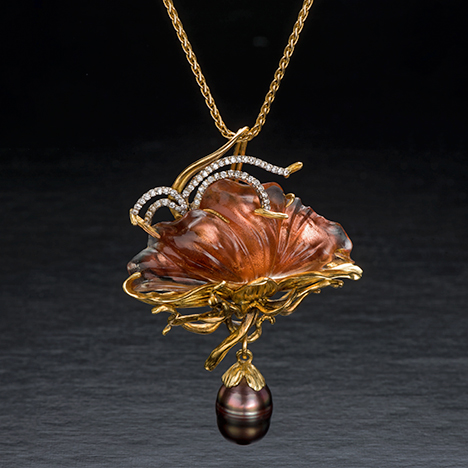18K gold pin with sunstone, Tahitian pearl, and diamond.