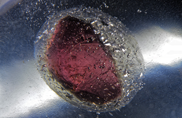 Gas bubbles surrounding garnet Gas bubbles surrounding garnet