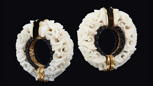 Carved tagua seed hoop earrings.