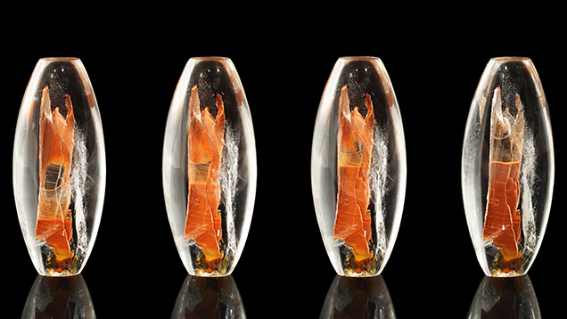 The tiny brown particles are mobile within the quartz host.