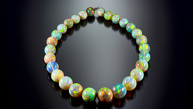 Opal strand exhibiting vibrant play-of-color.