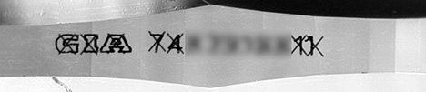 Figure 2. GIA’s standard procedure is to cross out the counterfeit inscription. Image by GIA staff. Figure 2. GIA’s standard procedure is to cross out the counterfeit inscription. Image by GIA staff.