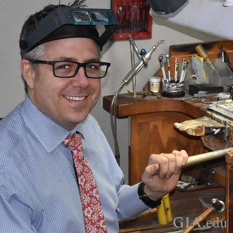 Man at a jeweler’s bench. Man at a jeweler’s bench.