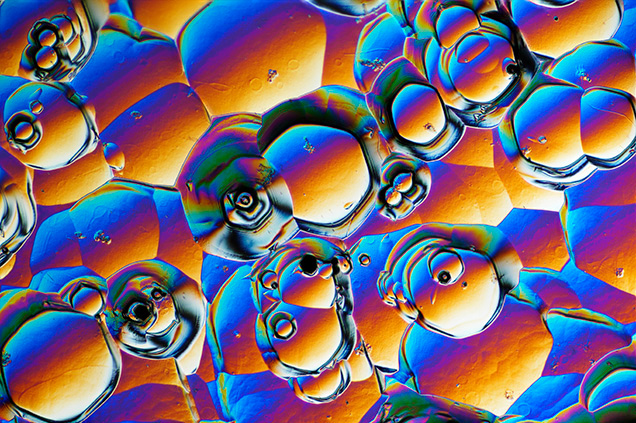 Sub-hexagonal etch pits in synthetic moissanite. Sub-hexagonal etch pits in synthetic moissanite.