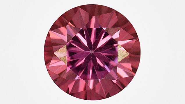 Synthetic moissanite coated with a thin colored film