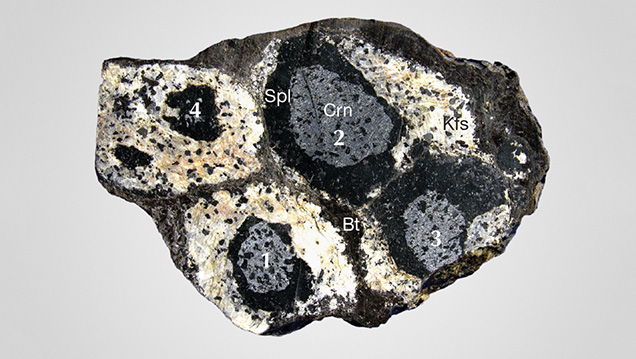 Stages of spinel corona formation around corundum grains Stages of spinel corona formation around corundum grains