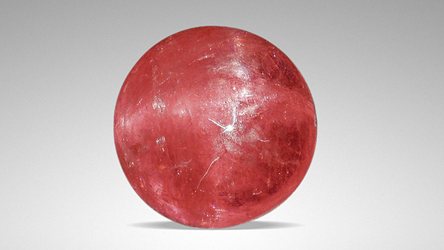 Orangy pink rhodochrosite displaying asterism. Orangy pink rhodochrosite displaying asterism.