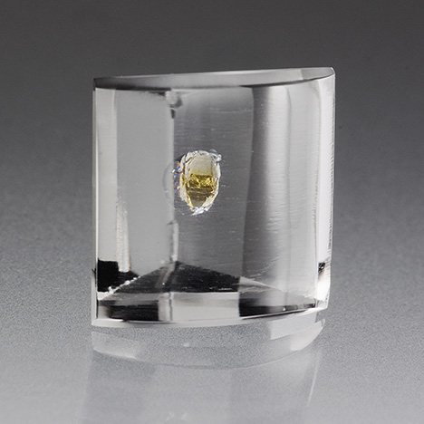 A transparent yellow crystal can be seen in a 10.54 ct rock crystal quartz host. A transparent yellow crystal can be seen in a 10.54 ct rock crystal quartz host.
