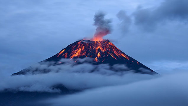 Figure 2. Eruption of the Tungurahua volcano in Ecuador. Various gem minerals can crystallize from molten magmas in the earth’s crust or when the magmas erupt at the surface. Magmas also bring up pieces of mantle or crustal rocks called xenoliths that are of great value for scientific study. Courtesy of Sebastián Crespo Photography/Moment/Getty Images.