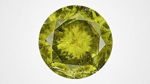 Figure 1. The face-up view of a 2.32 ct faceted pallasitic peridot, the largest extraterrestrial peridot seen at GIA to date. Photo by Diego Sanchez. Figure 1. The face-up view of a 2.32 ct faceted pallasitic peridot, the largest extraterrestrial peridot seen at GIA to date. Photo by Diego Sanchez.