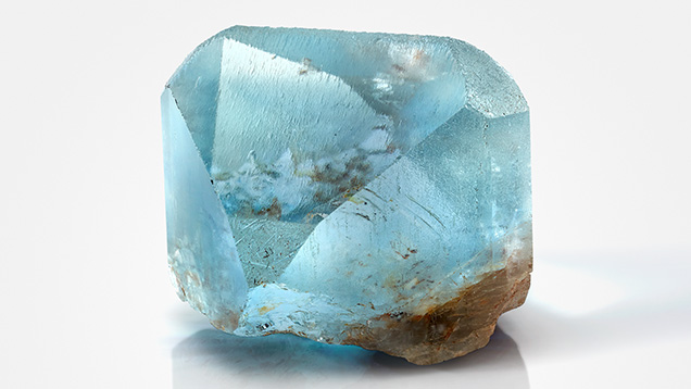 Figure 1. A fine 925 ct crystal that was formerly displayed in the Texas State Capitol and sat on the governor’s desk in 1969 when the legislature adopted blue Texas topaz as the state gem. This specimen was found in 1904 and now resides in the Hamman Gem and Mineral Gallery in the Department of Earth and Planetary Sciences at the University of Texas at Austin (catalog no. B0344). Photo by Blanca Espinoza. Figure 1. A fine 925 ct crystal that was formerly displayed in the Texas State Capitol and sat on the governor’s desk in 1969 when the legislature adopted blue Texas topaz as the state gem. This specimen was found in 1904 and now resides in the Hamman Gem and Mineral Gallery in the Department of Earth and Planetary Sciences at the University of Texas at Austin (catalog no. B0344). Photo by Blanca Espinoza.