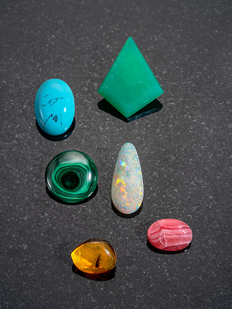 Figure 2. The gems shown here formed in sediments by the evaporation of water or from mineralized solutions (amber is solidified tree resin). From left to right and top to bottom: 59.88 ct turquoise, Turkey; 75.30 ct chrysoprase, Queensland, Australia; 67.79 ct malachite, Democratic Republic of Congo; 19.56 ct opal, Brazil; 14.67 ct amber, Poland; and 28.14 ct rhodochrosite, Argentina. Composite image by Robert Weldon. Figure 2. The gems shown here formed in sediments by the evaporation of water or from mineralized solutions (amber is solidified tree resin). From left to right and top to bottom: 59.88 ct turquoise, Turkey; 75.30 ct chrysoprase, Queensland, Australia; 67.79 ct malachite, Democratic Republic of Congo; 19.56 ct opal, Brazil; 14.67 ct amber, Poland; and 28.14 ct rhodochrosite, Argentina. Composite image by Robert Weldon.