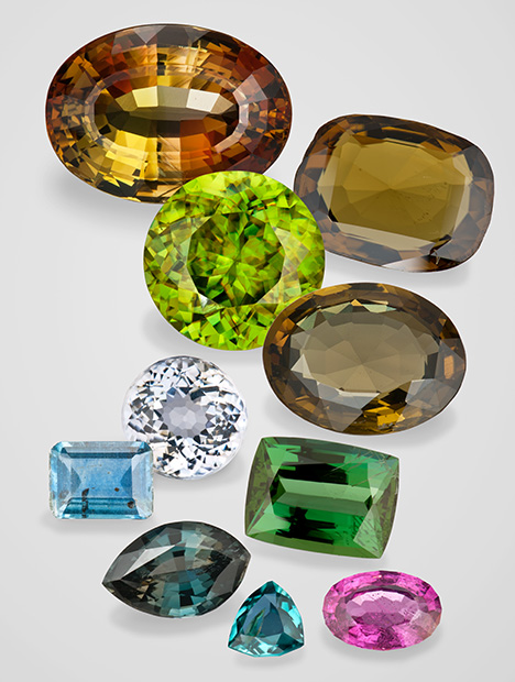 Figure 4. Alluvial gems that are less often found loose in sediments. From left to right and top to bottom: 14.41 ct andalusite, Brazil; 18.50 ct sinhalite, Sri Lanka; 13.00 ct sphene, Madagascar; 11.19 ct kornerupine, Sri Lanka; 2.62 ct sillimanite, Sri Lanka; 3.20 ct zoisite, Tanzania; 2.77 ct kyanite, Madagascar; 1.68 ct sapphirine, Sri Lanka; 0.29 ct grandidierite, Sri Lanka; and 1.23 ct taaffeite, Sri Lanka. Composite image by Robert Weldon. Figure 4. Alluvial gems that are less often found loose in sediments. From left to right and top to bottom: 14.41 ct andalusite, Brazil; 18.50 ct sinhalite, Sri Lanka; 13.00 ct sphene, Madagascar; 11.19 ct kornerupine, Sri Lanka; 2.62 ct sillimanite, Sri Lanka; 3.20 ct zoisite, Tanzania; 2.77 ct kyanite, Madagascar; 1.68 ct sapphirine, Sri Lanka; 0.29 ct grandidierite, Sri Lanka; and 1.23 ct taaffeite, Sri Lanka. Composite image by Robert Weldon.