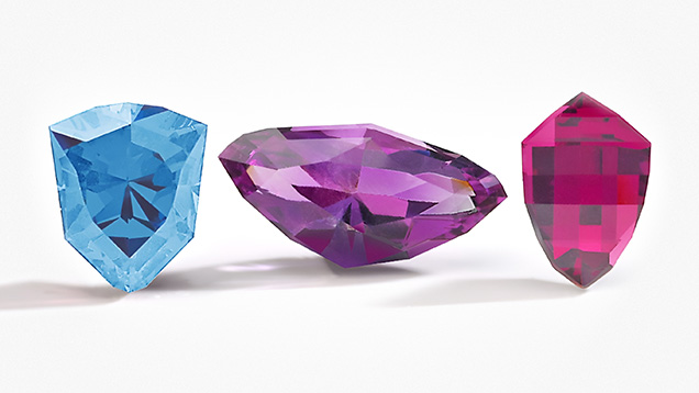 Figure 2. Gemstone cutters in Kenya, Malawi, and Zambia developed cuts to represent their countries in Virtu Gem’s National Gem Cut Course. Left to right: the Kenya Cheetah Head, Zambia Eagle, and Malawi Mbuna Fish cuts in aquamarine, amethyst, and rhodolite garnet. Photo courtesy of Virtu Gem. Figure 2. Gemstone cutters in Kenya, Malawi, and Zambia developed cuts to represent their countries in Virtu Gem’s National Gem Cut Course. Left to right: the Kenya Cheetah Head, Zambia Eagle, and Malawi Mbuna Fish cuts in aquamarine, amethyst, and rhodolite garnet. Photo courtesy of Virtu Gem.