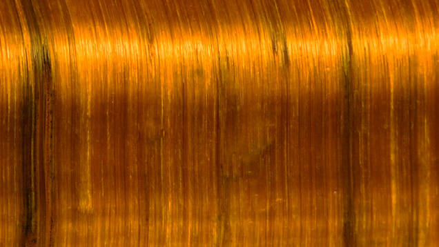Figure 9. Chatoyancy in a polished section of tiger’s-eye. A characteristic of this gem is the local variability in the orientation of the cat’s-eye, causing different bands of reflected light when rotated relative to a point light source. Photomicrograph by Ying Yan; field of view 1.3 mm. Figure 9. Chatoyancy in a polished section of tiger’s-eye. A characteristic of this gem is the local variability in the orientation of the cat’s-eye, causing different bands of reflected light when rotated relative to a point light source. Photomicrograph by Ying Yan; field of view 1.3 mm.