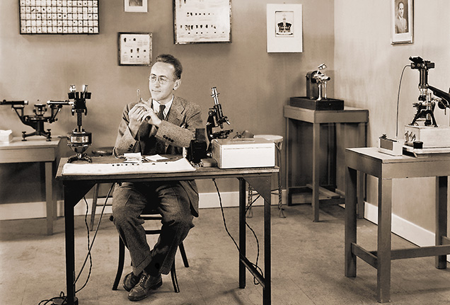 Figure 2. Robert Shipley Jr. working with gem testing equipment at GIA’s early headquarters in Los Angeles. This 1937 photo is from a three-minute color film by Paramount Pictures for its “Popular Science” series, produced between 1935 and 1949 and shown in movie theaters nationwide. Figure 2. Robert Shipley Jr. working with gem testing equipment at GIA’s early headquarters in Los Angeles. This 1937 photo is from a three-minute color film by Paramount Pictures for its “Popular Science” series, produced between 1935 and 1949 and shown in movie theaters nationwide.