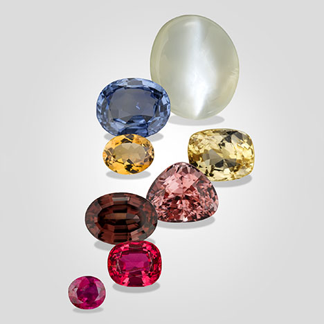 Figure 1. Composite of Burmese gemstones from the Mogok region, from top to bottom: 59.94 ct moonstone, 9.10 ct blue sapphire, 4.67 ct orangy yellow tourmaline, 6.75 ct yellow sapphire, 8.09 ct pink scapolite, 7.19 ct reddish brown zircon, 4.79 ct red spinel, and 1.65 ct ruby. Photos of the moonstone and zircon by Orasa Weldon; all others by Robert Weldon. Courtesy of GIA’s Dr. Edward J. Gübelin collection. Figure 1. Composite of Burmese gemstones from the Mogok region, from top to bottom: 59.94 ct moonstone, 9.10 ct blue sapphire, 4.67 ct orangy yellow tourmaline, 6.75 ct yellow sapphire, 8.09 ct pink scapolite, 7.19 ct reddish brown zircon, 4.79 ct red spinel, and 1.65 ct ruby. Photos of the moonstone and zircon by Orasa Weldon; all others by Robert Weldon. Courtesy of GIA’s Dr. Edward J. Gübelin collection.