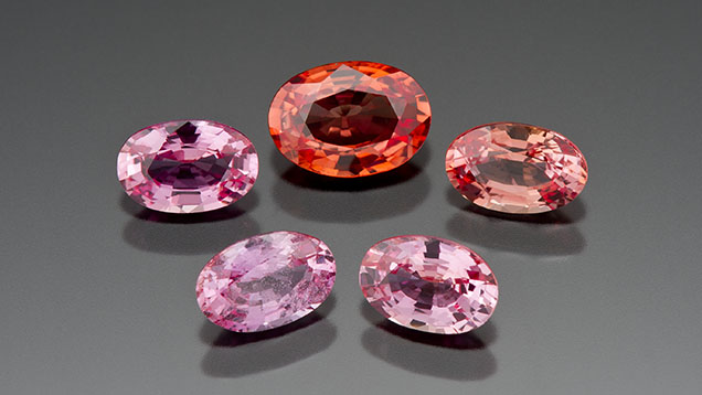 Figure 1. Gem laboratories saw an unusual influx of padparadscha-colored sapphires in the early 2000s and quickly attributed their color to beryllium diffusion. This group of pink and orangy pink treated sapphires ranges from 0.51 to 0.84 ct. Photo by Kevin Schumacher. Figure 1. Gem laboratories saw an unusual influx of padparadscha-colored sapphires in the early 2000s and quickly attributed their color to beryllium diffusion. This group of pink and orangy pink treated sapphires ranges from 0.51 to 0.84 ct. Photo by Kevin Schumacher.
