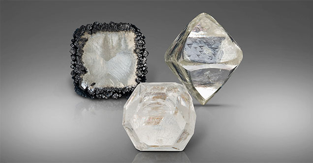 Figure 6. The different growth conditions of natural and laboratory-grown diamonds provide distinctive clues that allow gemologists to conclusively separate them. Here laboratory-grown CVD (left) and HPHT (middle) rough diamonds are pictured next to a natural rough diamond (right). Photos by Robert and Orasa Weldon; courtesy of the GIA Sir Ernest Oppenheimer Student collection (left). Figure 6. The different growth conditions of natural and laboratory-grown diamonds provide distinctive clues that allow gemologists to conclusively separate them. Here laboratory-grown CVD (left) and HPHT (middle) rough diamonds are pictured next to a natural rough diamond (right). Photos by Robert and Orasa Weldon; courtesy of the GIA Sir Ernest Oppenheimer Student collection (left).