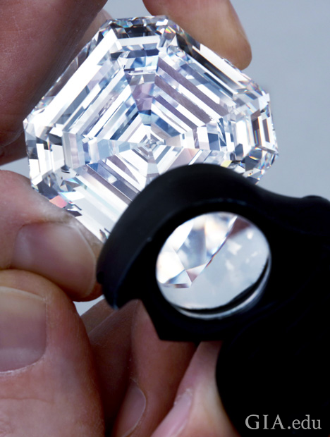 Looking at a large diamond with a loupe Looking at a large diamond with a loupe