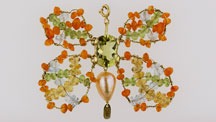 Designed by Bialice Duarte, this butterfly pendant in 18K yellow gold features a fantasy cut green gold quartz, peridot, aquamarine, citrine, tourmaline, and a freshwater rose pearl. 