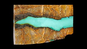 Figure 7. Turquoise collected from the Tianhu East mines. Greenish blue (3.11 g) turquoise sample investigated in this research. The matrix consists of quartzite with limonization. Photo by Ling Liu and Qiaoqiao Li. Figure 7. Turquoise collected from the Tianhu East mines. Greenish blue (3.11 g) turquoise sample investigated in this research. The matrix consists of quartzite with limonization. Photo by Ling Liu and Qiaoqiao Li.
