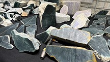 Figure 1. The rough Guatemalan jadeite jade sold by Yax Tun Minerals included blue, green, and lavender hues, with blue being the most prevalent. Photo by Tao Hsu; courtesy of Yax Tun Minerals. Figure 1. The rough Guatemalan jadeite jade sold by Yax Tun Minerals included blue, green, and lavender hues, with blue being the most prevalent. Photo by Tao Hsu; courtesy of Yax Tun Minerals.
