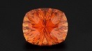A bright orange, multi-faceted gem.