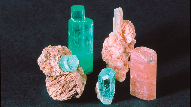 Morganite. One of the advantages of beryl is its wide color range. These crystals show pastel shades: aquamarine's green and blue and morganite's pink. -photo credit Alan Jobbins.