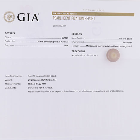 A quahog pearl sitting on a printed GIA Pearl Identification Report. A quahog pearl sitting on a printed GIA Pearl Identification Report.