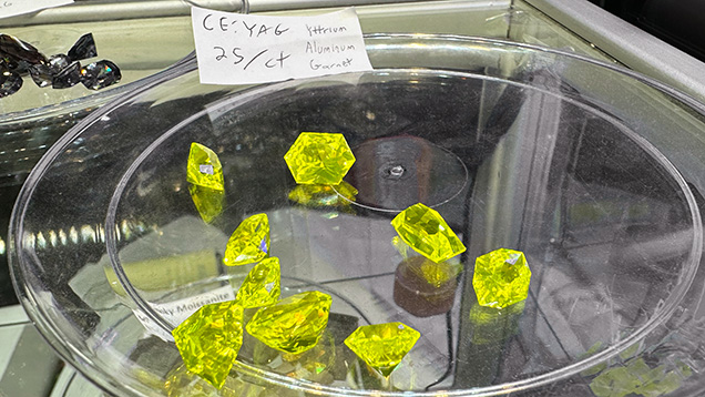 Figure 1. Yellow to greenish yellow faceted cerium-doped YAG “lumogarnets” ranging from 4 to 12 ct apiece. Photo by Lisa Kennedy; courtesy of Turtle’s Hoard. Figure 1. Yellow to greenish yellow faceted cerium-doped YAG “lumogarnets” ranging from 4 to 12 ct apiece. Photo by Lisa Kennedy; courtesy of Turtle’s Hoard.