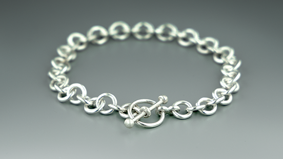 Create a handmade chain and toggle clasp in sterling silver. Learn skills like soldering, chain assembly, forming a wire loop, fusing metal with a torch, and making a toggle clasp Create a handmade chain and toggle clasp in sterling silver. Learn skills like soldering, chain assembly, forming a wire loop, fusing metal with a torch, and making a toggle clasp