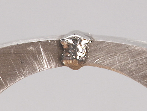 Platinum ring shank joint, overfilled with platinum cobalt after laser welding. Platinum ring shank joint, overfilled with platinum cobalt after laser welding.