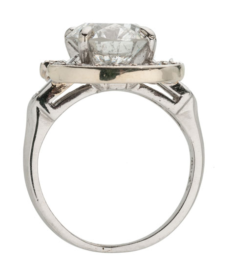 Side view of a platinum ring with a white gold and diamond halo surrounding the center stone Side view of a platinum ring with a white gold and diamond halo surrounding the center stone