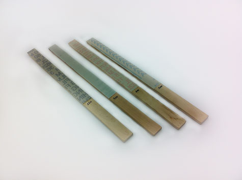 Four abrasive sticks containing micro-finishing film in four different abrasive grits. Four abrasive sticks containing micro-finishing film in four different abrasive grits.