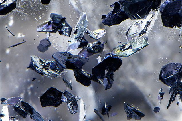 Hexagonal molybdenite crystals in phantom plane of quartz.