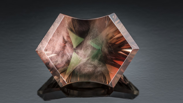 This 11-ct. bicolor sunstone is highly desirable for its color alone. An attractive display of aventurescence and a unique cut make it even more valuable. – Robert Weldon This 11-ct. bicolor sunstone is highly desirable for its color alone. An attractive display of aventurescence and a unique cut make it even more valuable. – Robert Weldon