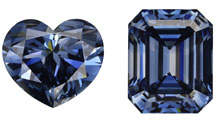 On the left is a 5.26 ct Fancy deep blue heart shape HPHT synthetic diamond. On the right is a 5.27 ct Fancy deep blue emerald cut HPHT synthetic diamonds. 