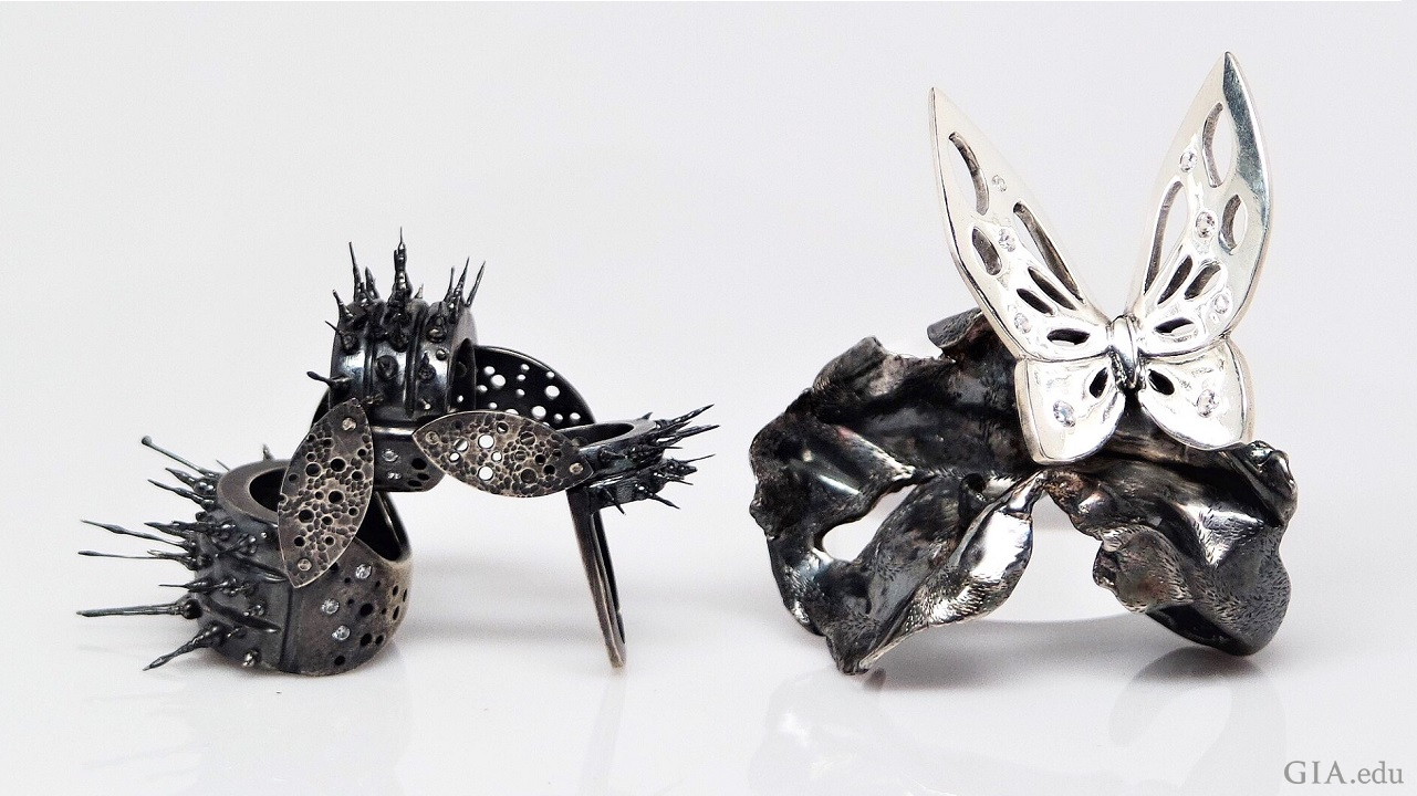 The caterpillar ring on the left is jointed so it can move and the butterfly ring on the right features dark and light sterling silver: a light butterfly on a dark cocoon. The caterpillar ring on the left is jointed so it can move and the butterfly ring on the right features dark and light sterling silver: a light butterfly on a dark cocoon.