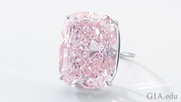 The pink diamond is a cushion-modified brilliant cut set in a ring.