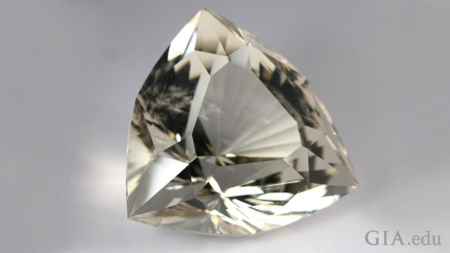 Six-sided shield-shaped, intricately carved topaz. Six-sided shield-shaped, intricately carved topaz.