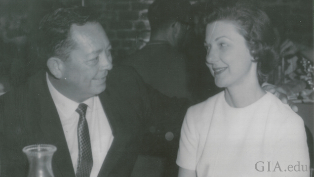 A man and woman sit at a restaurant table gazing at one another. A man and woman sit at a restaurant table gazing at one another.
