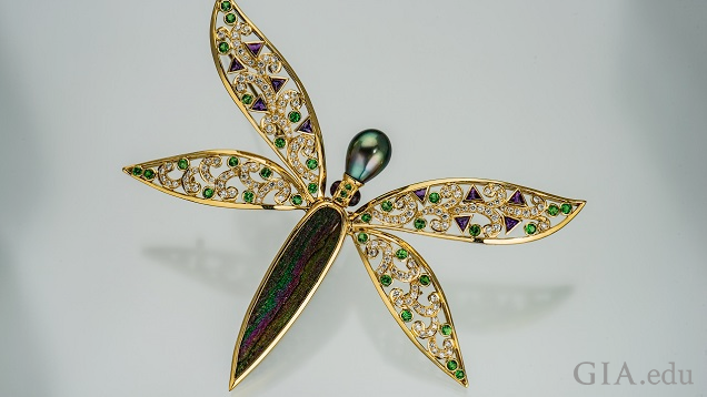 Dragon fly pin with drusy body and pearl head; wings are set with clear and green gems.