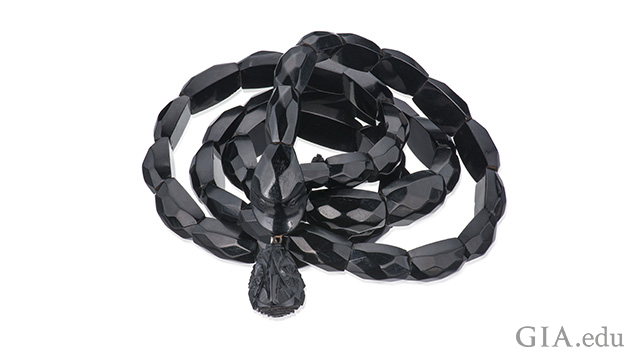 A bracelet of black jet beads on a coiled elastic to resemble a snake. A bracelet of black jet beads on a coiled elastic to resemble a snake.