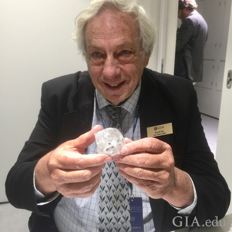 Man holds large rough diamond. Man holds large rough diamond.